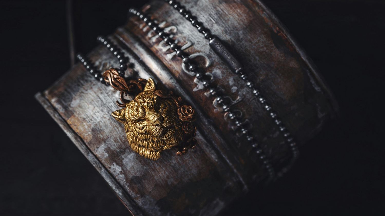 Lion's head pendant: An ancient Egyptian board game piece that was later repurposed into a magical religious object with baboons