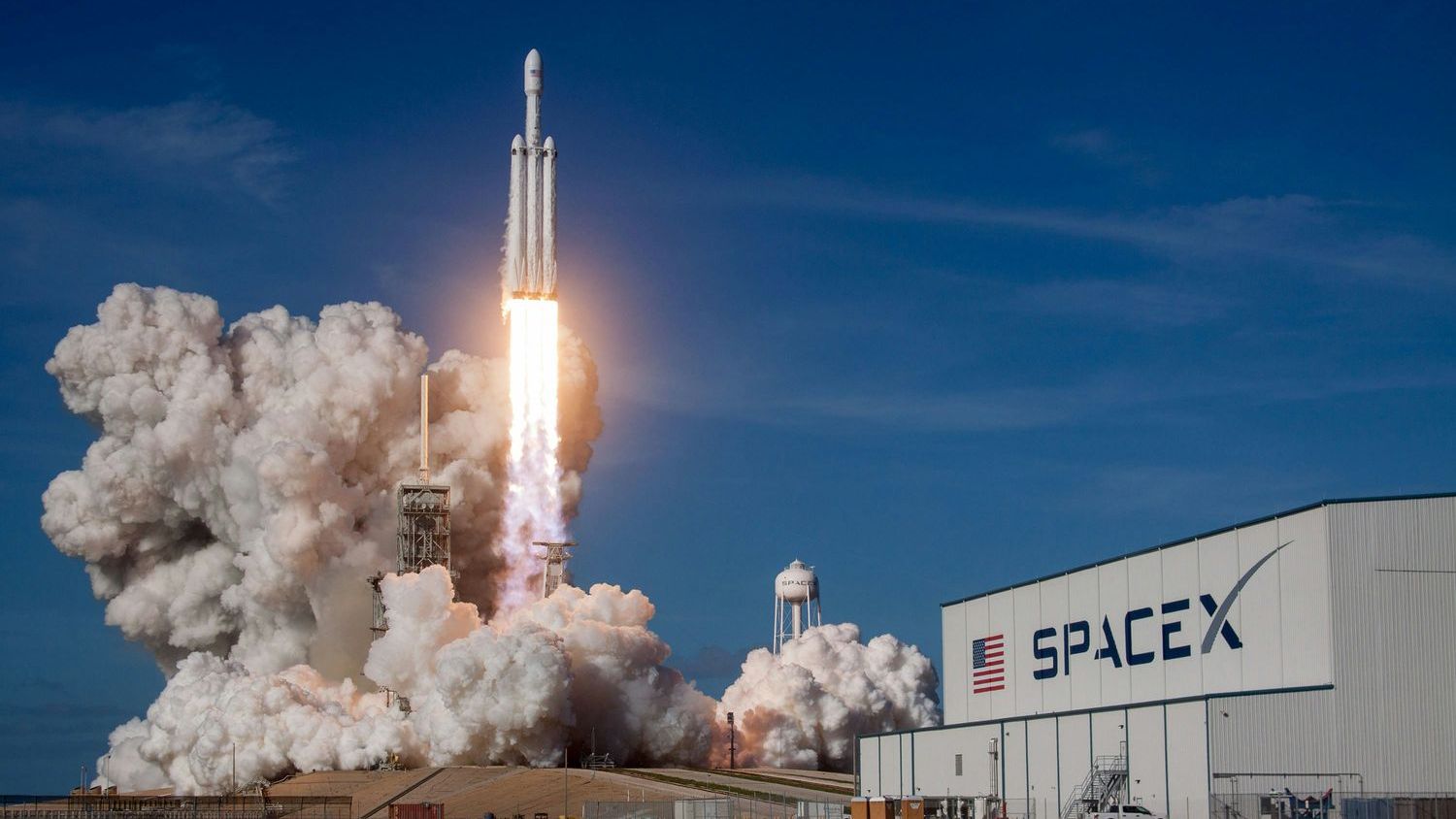 SpaceX is reflying its sixth cargo Dragon while Boeing’s crewed Starliner reverts to uncrewed resupply — and the $4.2B-versus-$2.6B contracts that produced both were signed the same day in 2014